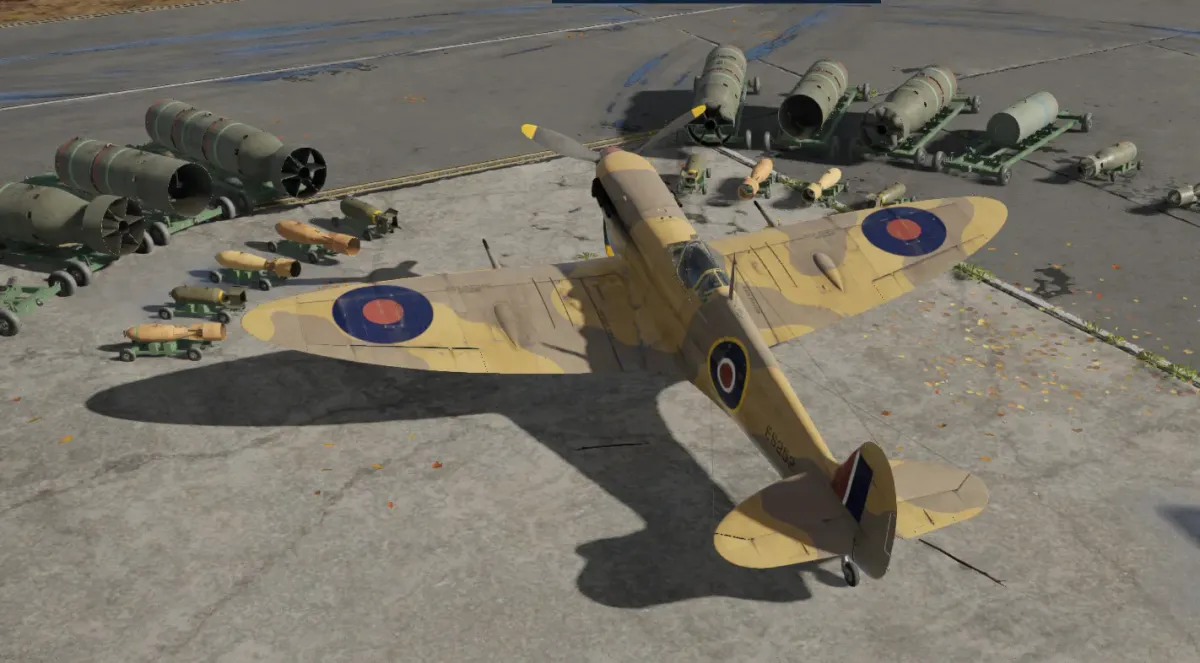 A desert-camouflage Spitfire on a runway, surrounded by bombs several times its own size